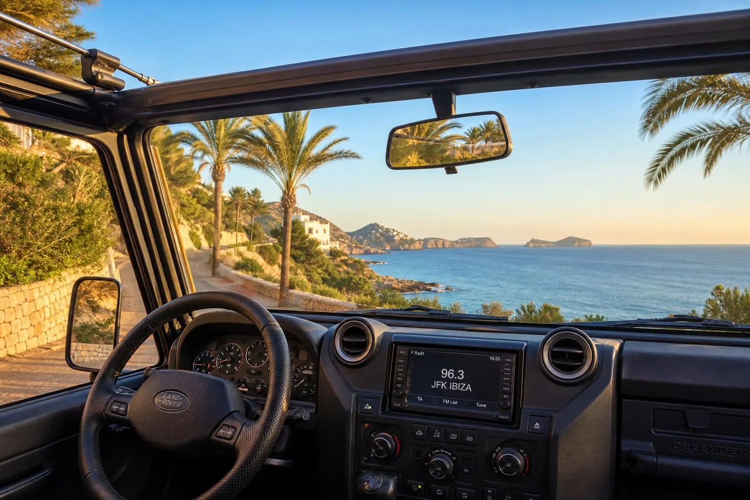 Land Rover Defender met open dak op Ibiza, autoradio afgestemd op 96.3 JFK Ibiza